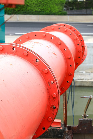 Large orange water pump pipe with Rust of metals. Corrosion of metal. Rust and corrosion in the weld  nut and bolt.の写真素材