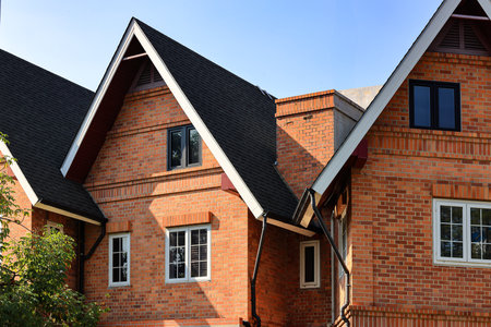 Building made of brick facade with white wooden windows.の写真素材