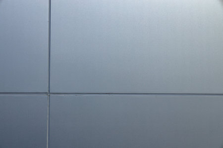 Close up detail of wall made from light blue synthetic materials on modern building.