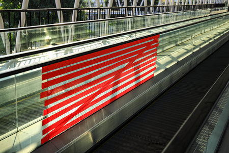 adhoc repair for Cracked or broken glass wall of public Automatic escalator walkway. Red tape Repair...