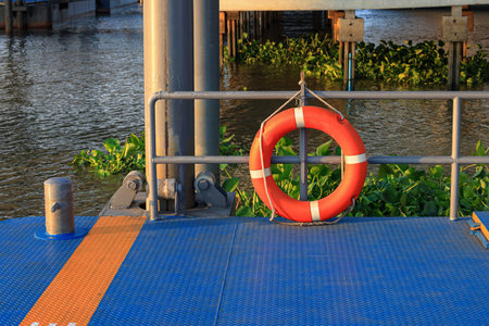 A rescue lifebuoy which installed on riverbank corridor railing, stand by for people overboard into...