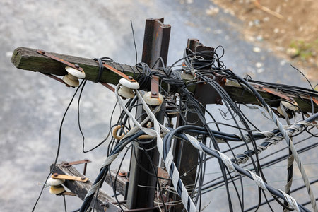 Old, abandoned electric pole, The electric post show with high voltage construction and power lines.の写真素材