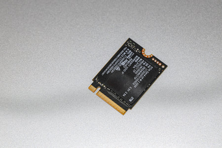 NVME PCIe solid-state drive in the M.2 2230 form factor isolated on metal background.