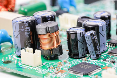 Electromagnetic components produced from copper element and many of capacitors on electronic circuit.の写真素材