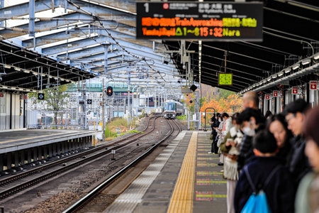 The train approached the platform to take up passengers in rainstorm.