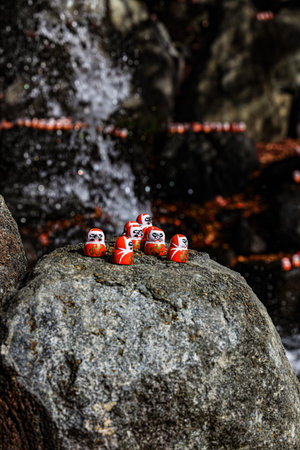 Symbol of determination, good luck charm in Japanese, Many traditional red Daruma doll on the rock at Katsuo-ji temple, Osaka, Japan.の写真素材
