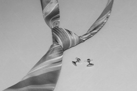 Tie and cufflinks in the black and white background の写真素材