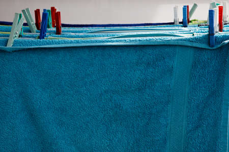 Towels drying outside after being washed and pinned on the clothes rackの写真素材