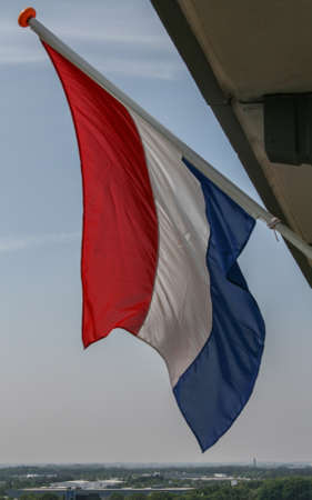 Dutch flag waving in the wind for the queens birthdayの写真素材