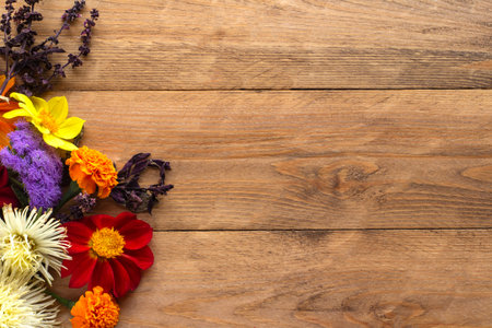 Autumn flower arrangement on the left side of the wooden background. Copyspace.