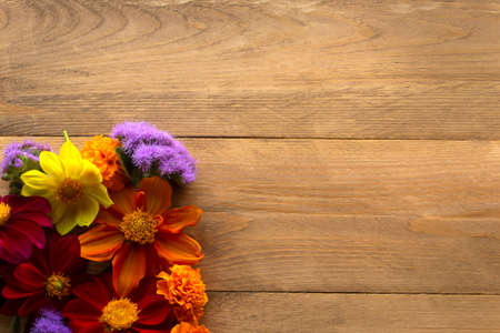 Floral arrangement on a wooden background with copy space. It can be used as a blank for a design.の写真素材