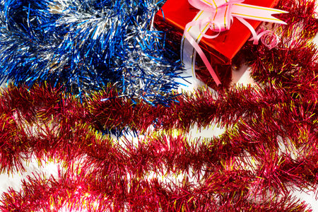 New Year's tinsel and decorations laid out in the shape of the American flag. Soft focus. Can be...