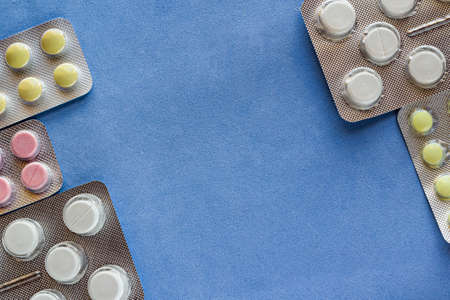 Blister frame with pills and blue background. Copyspace.の写真素材