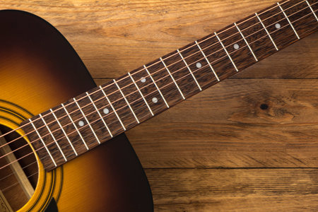 Acoustic guitar on a wooden background.の写真素材