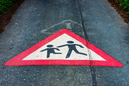 The Traffic sign Attention children playing on the floor of a street
