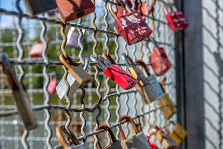 Various locks with names on a metal gridのeditorial素材