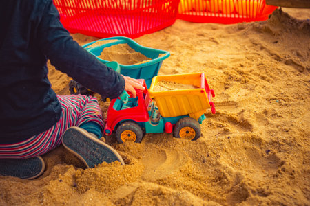 Child is playing in the sandの写真素材