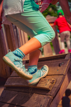 Child climbs on a climbing frameの写真素材