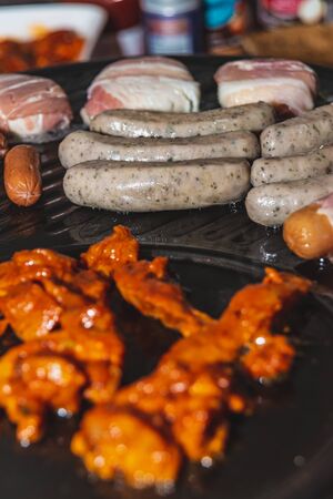 Different kinds of meat are prepared on the hot stoneの写真素材