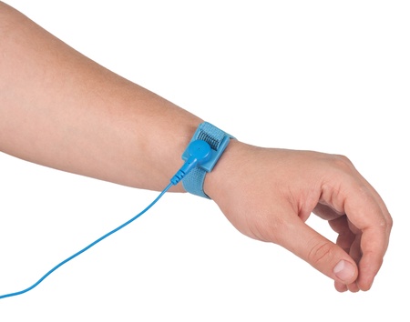Ground bracelet on man hand isolated on white background   An antistatic wrist strap, ESD wrist strap, or ground bracelet is an antistatic device used to safely ground a person working on very sensitive electronic equipment の写真素材