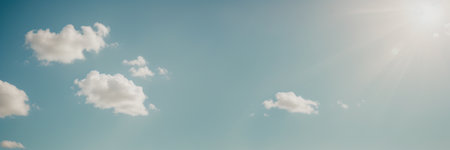 Blue sky with white clouds and sun. Nature background. Panoramic image.の素材