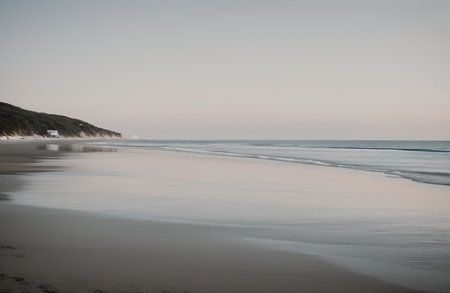 Long exposure of a beach in the late afternoon with a boat in the backgroundの素材