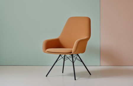 Orange armchair on a green wall background. 3d render.の素材