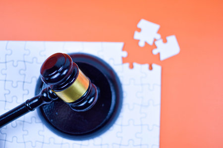 Judge's gavel atop unfinished puzzle symbolizes justice as a complex system, requiring all facts to complete the legal picture.の写真素材