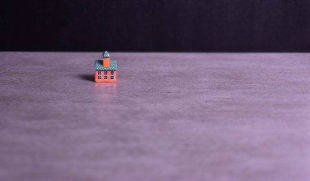 Brightly colored model building on dark background emphasizes architectural detail, isolation, and visual contrast in a minimalistic composition.の写真素材