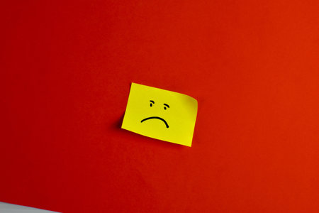 Yellow sticky note on red background.の写真素材