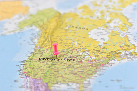 North America map with pink pushpin on Kansas, showing U.S. states, Canada to the north, and Mexico...