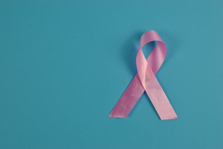 Pink ribbon on blue background.の写真素材