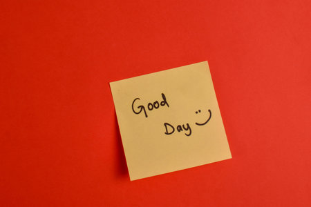 Handwritten note on red background reads with smiley face symbolic expression of affection and emotional warmth.の写真素材