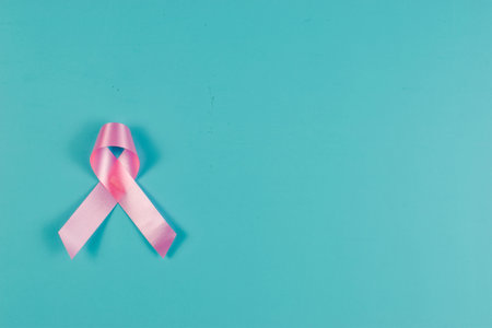 Pink ribbon on blue surface.の写真素材