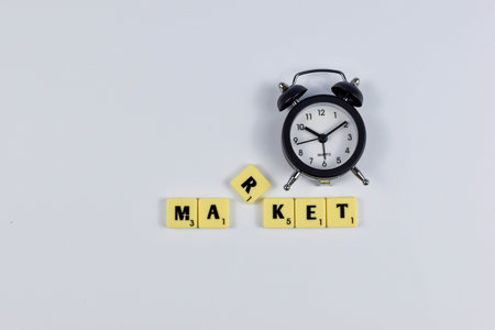 Scrabble tiles spell MARKET with elevated R suggesting emphasis or disruption in an otherwise orderly economic concept.の写真素材