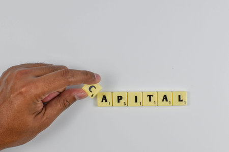 Scrabble tiles spell a finance term for a firm mix of debt and equity used to fund operations.