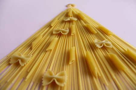 The creative concept of the Christmas tree made out of different kinds of pasta.の写真素材