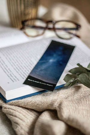hygge flatlay photo of a book sweater and a bookmarkの写真素材