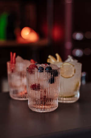alcoholic drinks on a bar with fruits and iceの写真素材