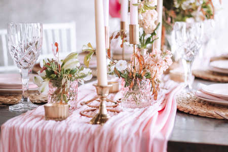 pink wedding party table decoration with candles and menuの写真素材