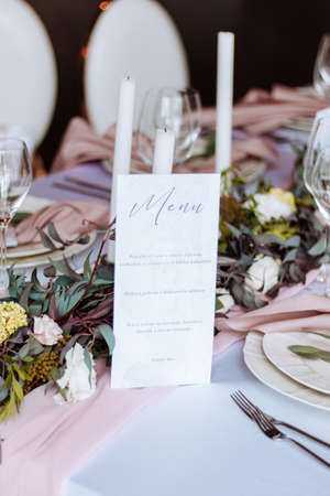 pink wedding party table decoration with candles and menuの写真素材