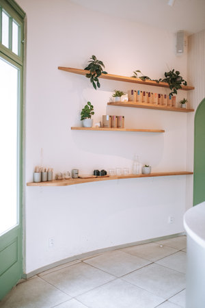 Interior of a modern kitchen with white walls and wooden shelves.の写真素材