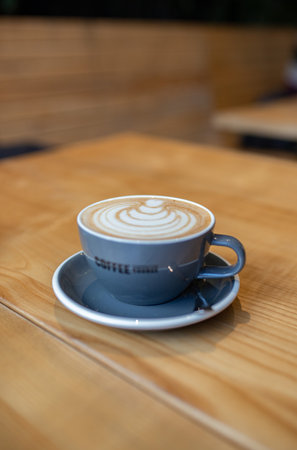 Coffee cup on wooden table in coffee shop, stock photoの写真素材