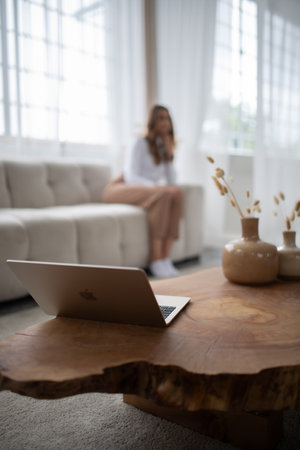 Woman using laptop at home in the living room. Freelance business concept.の写真素材