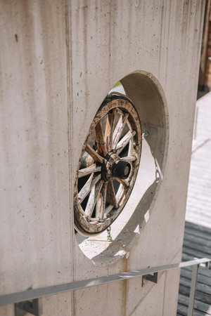 Wooden wheel of an old car on a white concrete wall.の写真素材