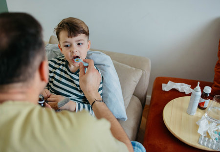 Dad gives his son syrupの写真素材