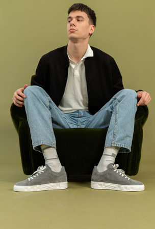 Man posing with shoes in studio