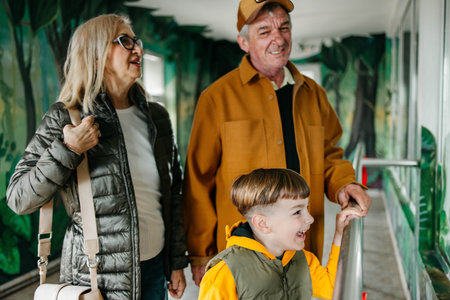 Happy grandparents having fun with their grandson