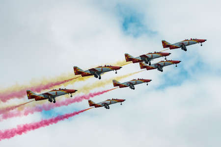 Seven planes at the airshow of planes in the sky of GijÃ³n.The smoke from the planes shows the colors of the flag of Spain.のeditorial素材