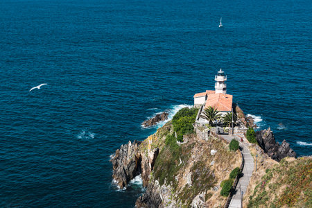 Landscape of the Cantabrian sea and the lighthouse of Cudillero, a typical coastal town of Asturias that is located in the north of Spainの写真素材